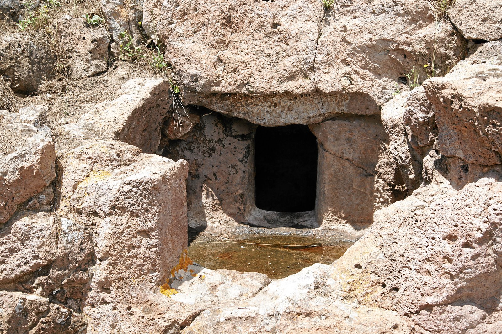 Rock-cut entrance to a domus de janas chamber tomb at the Montessu necropolis near Villaperuccio, Sardinia