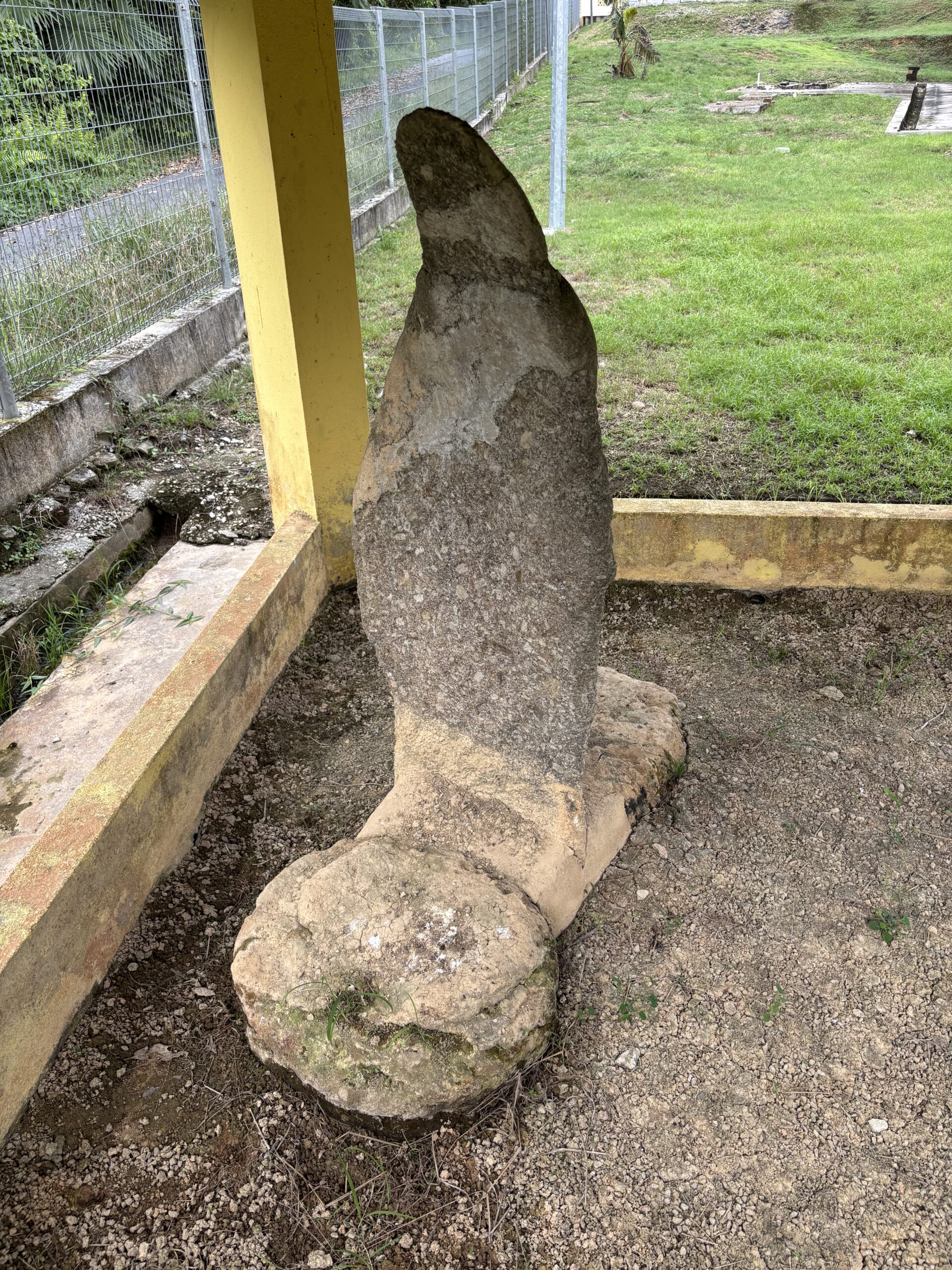 An isolated carved granite menhir standing at the Pengkalan Kempas complex in Negeri Sembilan