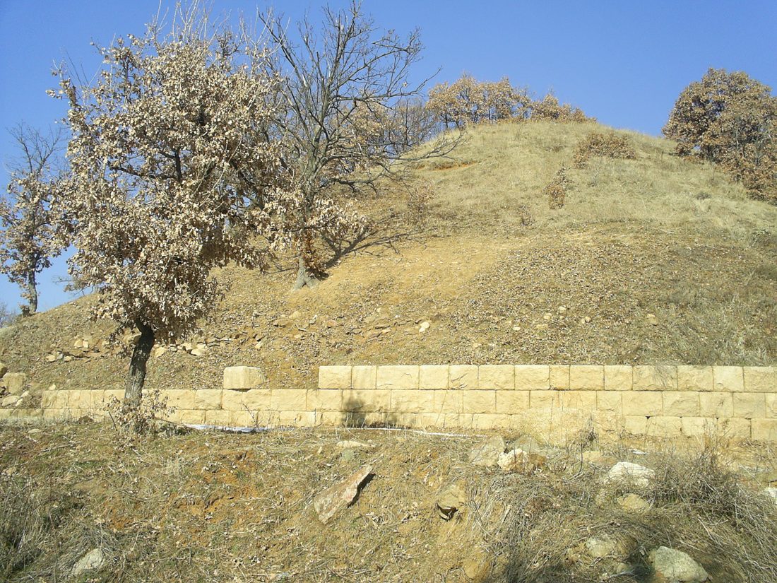 The stone crepis retaining wall ringing the base of the Chetinyova mound at the Thracian temple of Starosel, Bulgaria