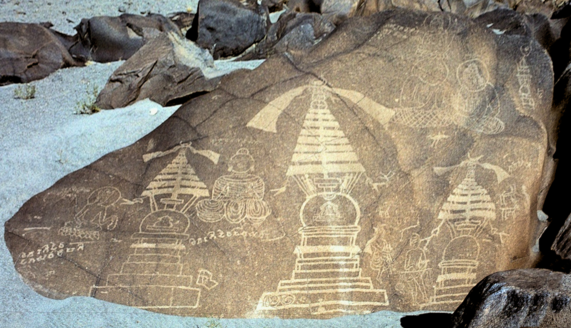 Chilas petroglyphs depicting ibex and a hunting scene chiselled into a weathered boulder in northern Pakistan