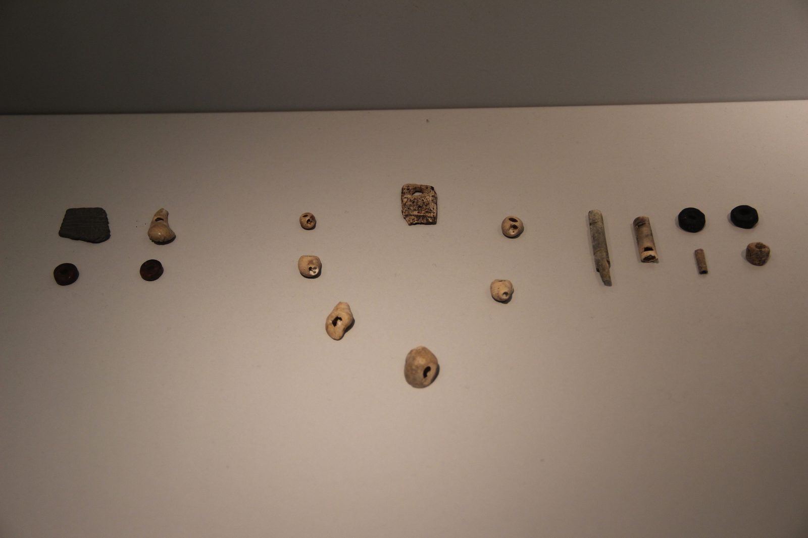 Perforated beads and pendants (personal ornaments) excavated from Las Caldas cave, on museum display