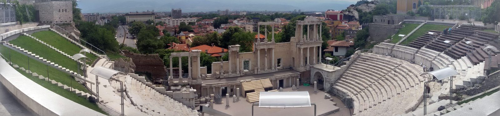 Wide panorama of the restored Roman theatre of Philippopolis in Plovdiv, Bulgaria, with the marble cavea and stage.