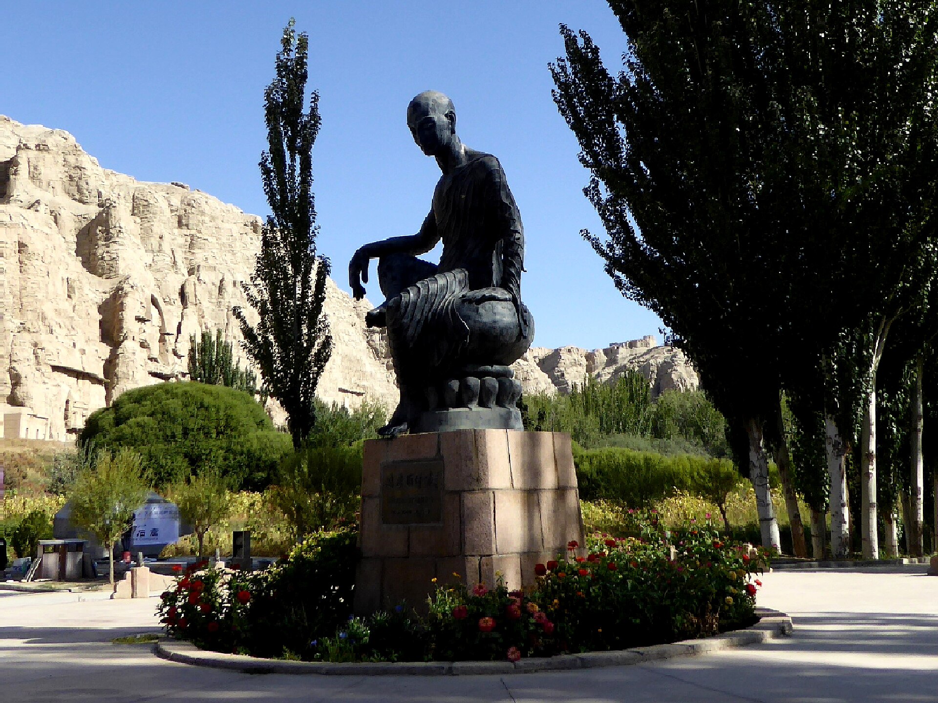 Seated bronze statue of the Kuchean translator-monk Kumarajiva in front of the Kizil Caves